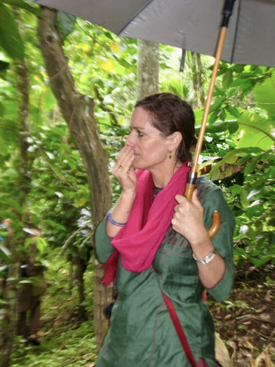 Niika Quistgard placing her hands on a vine on a tree in a garden